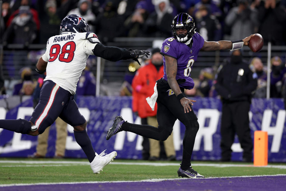 BALTIMORE, MARYLAND - JANUARY 20: Lamar Jackson #8 of the Baltimore Ravens scores an 8 yard touchdown against Sheldon Rankins #98 of the Houston Texans during the fourth quarter in the AFC Divisional Playoff game at M&T Bank Stadium on January 20, 2024 in Baltimore, Maryland. (Photo by Patrick Smith/Getty Images)