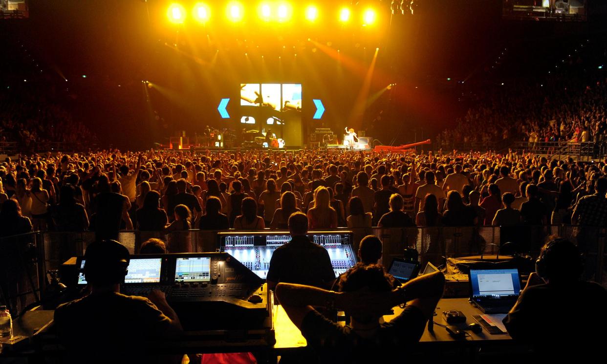 <span>Engineers on the sound and lighting desks watch behind the audience as Rihanna performs at Melbourne’s Rod Laver Arena in 2011.</span><span>Photograph: Martin Philbey/Redferns</span>