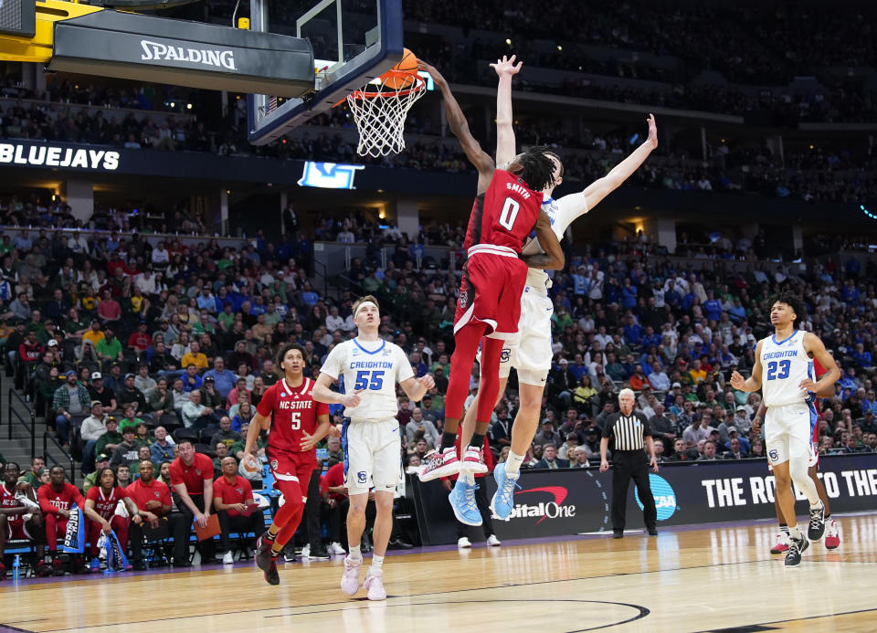 North Carolina State guard Terquavion Smith (0) dunks as Creighton center Ryan Kalkbrenner defends in the second half of a first-round college basketball game in the men's NCAA Tournament Friday, March 17, 2023, in Denver. (AP Photo/John Leyba)