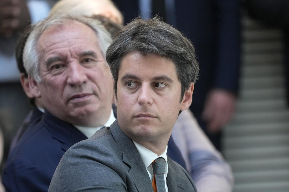 French Prime Minister Gabriel Attal and centrist politician Francois Bayrou, left, attend French President Emmanuel Macron's press conference Wednesday, June 12, 2024 in Paris. French President Emmanuel Macron called for moderate politicians from the left and the right to regroup to defeat the far-right in general elections. (AP Photo/Michel Euler)