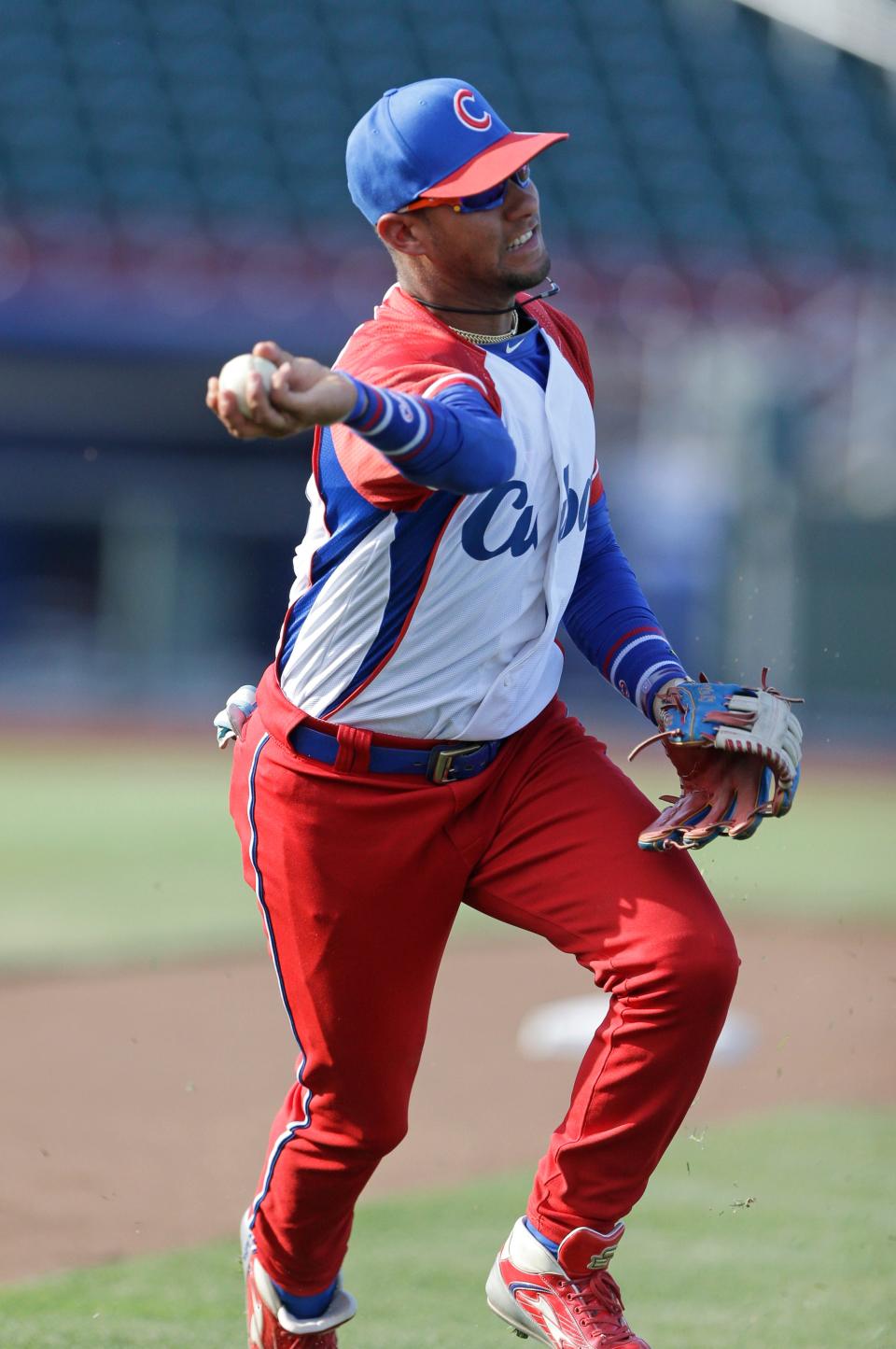 In this 2013 file photo, Yuli Gourriel warms up for Cuba prior to an exhibition baseball game against the United States in Papillion, Nebraska.