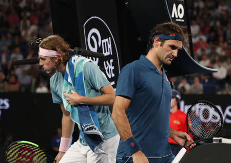 Tennis - Australian Open - Fourth Round - Melbourne Park, Melbourne, Australia, January 20, 2019. Switzerland’s Roger Federer and Greece’s Stefanos Tsitsipas during the match. REUTERS/Aly Song