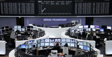 Traders are pictured at their desks in front of the DAX board at the Frankfurt stock exchange July 18, 2014. REUTERS/Remote/Stringer