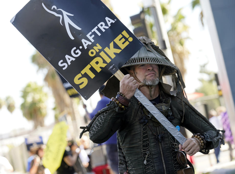 SAG-AFTRA member Bruce D. Mitchell participates in a post apocalyptic-themed picket line outside Netflix studios, Wednesday, Nov. 8, 2023, in Los Angeles. (AP Photo/Chris Pizzello)