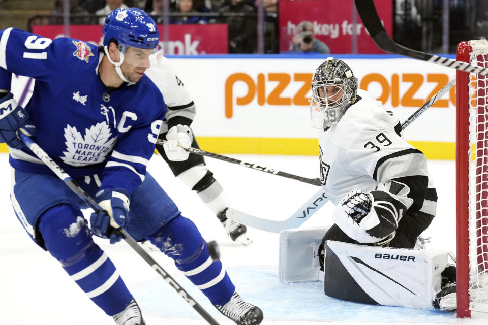 Los Angeles Kings goaltender Cam Talbot looks on as Toronto Maple Leafs' John Tavares goes after a loose puck during the second period of an NHL hockey game, Tuesday, Oct. 31, 2023 in Toronto. (Chris Young/The Canadian Press)