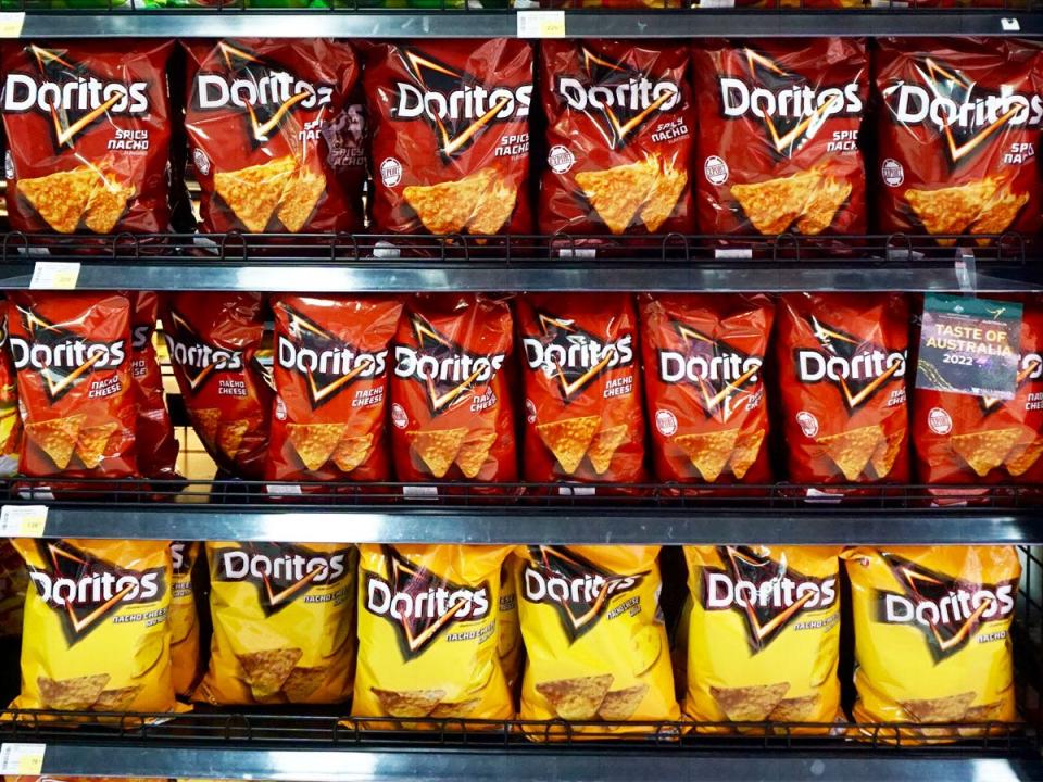 shelf of doritos in the bangkok grocery store aisle