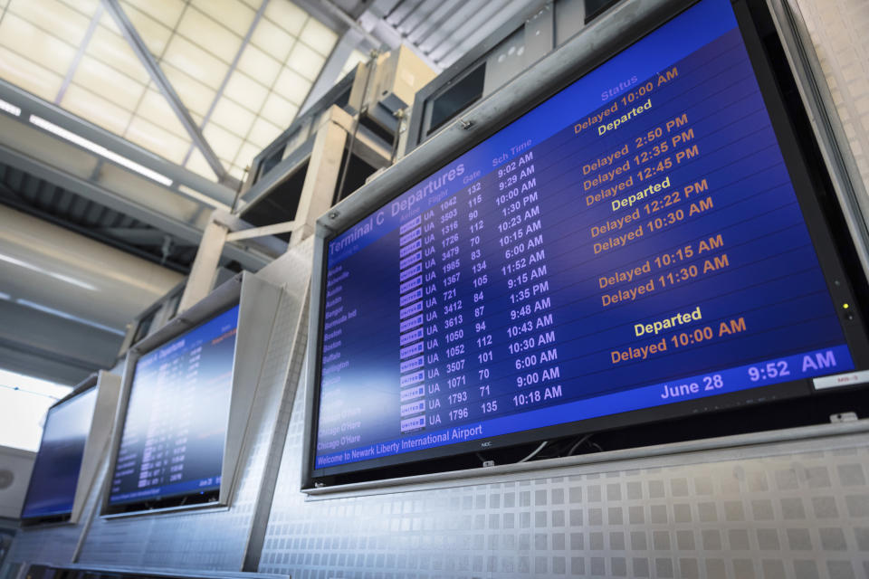 A screen displaying departure times and delayed flight information for Terminal C in Newark International Airport in Newark, N.J., Wednesday, June 28, 2023. Airline passengers face delays following flight cancellations due to storms in the region. (AP Photo/Stefan Jeremiah)