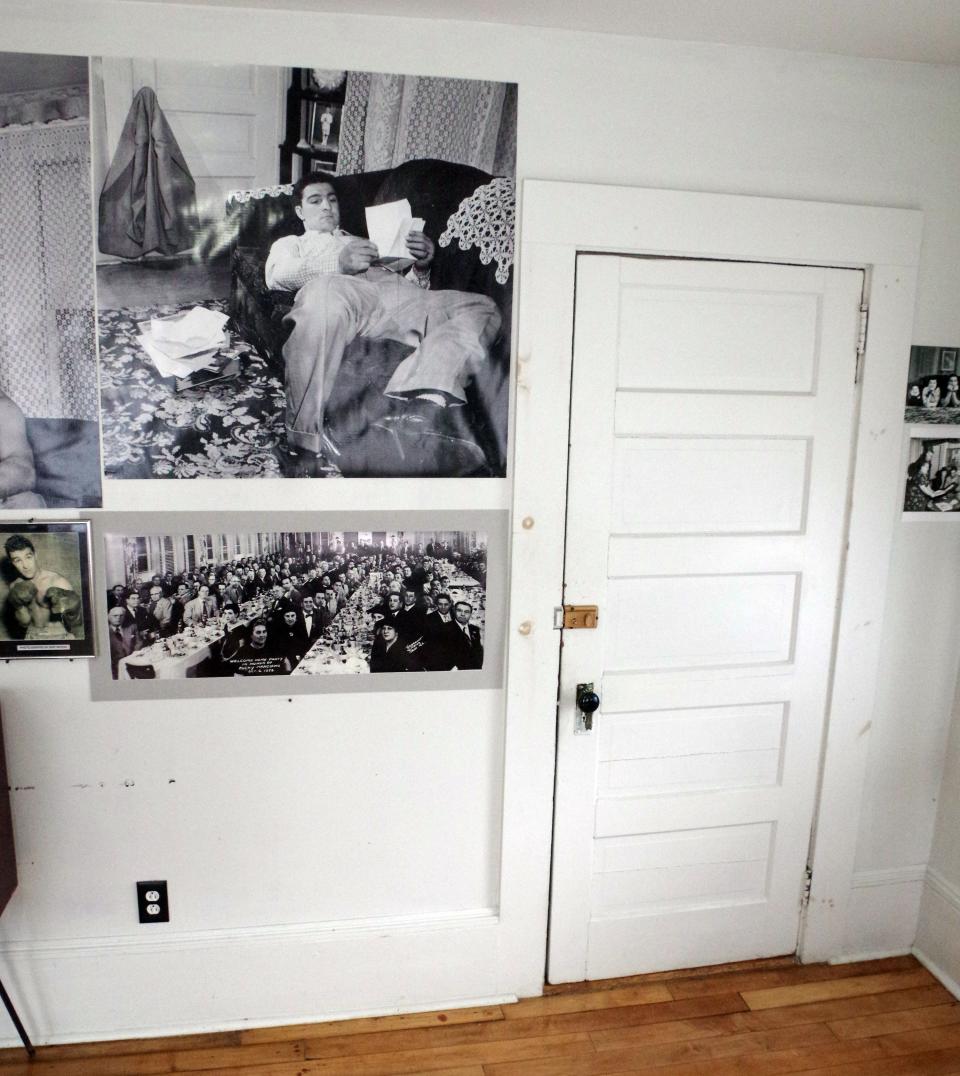 In the Marciano family home at 168 Dover St. in Brockton is a photograph of Rocky Marciano lounging on his couch looking at fan mail. In the photograph, his jacket is hanging on the doorknob, the very same door at the right in the same living room, seen on Monday, April 29, 2024.