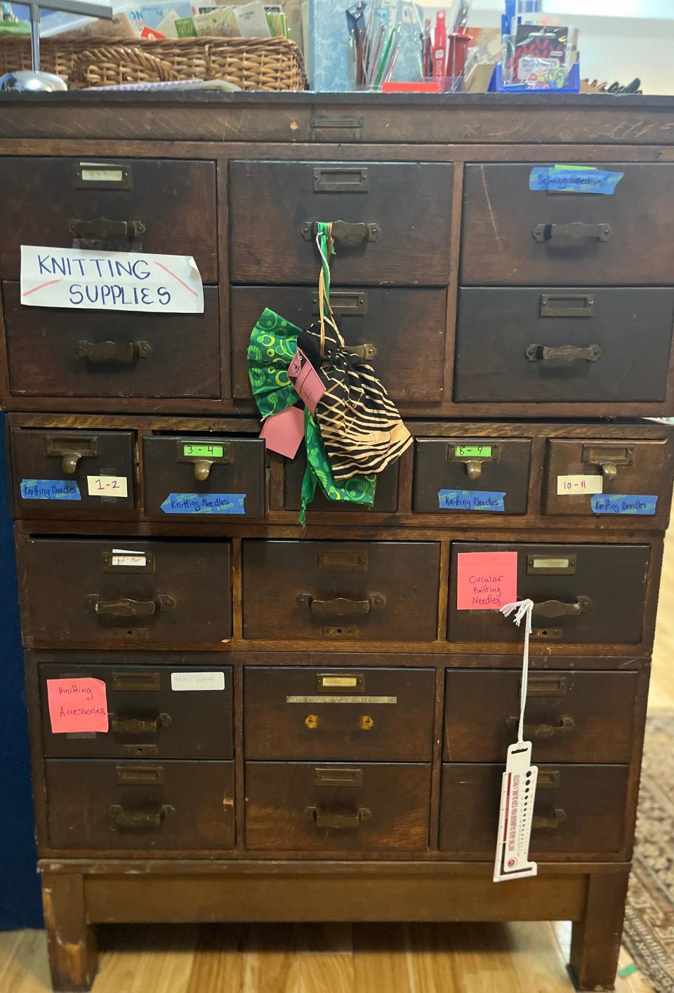 An old card catalog stores knitting supplies.
