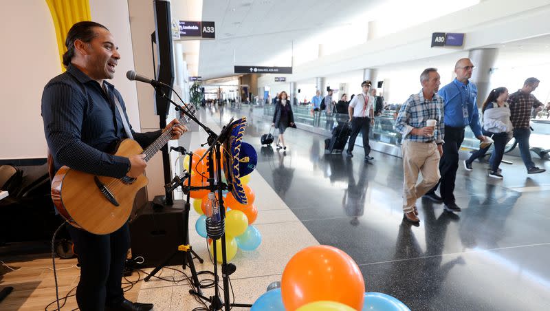 Jean Pierre De Rurange plays guitar and sings at Blue Iguana as travelers pass through Salt Lake City International Airport in Salt Lake City on Tuesday, Oct. 31, 2023. 13 new gates in Concourse A are now open, along with new concessions such as Blue Iguana.