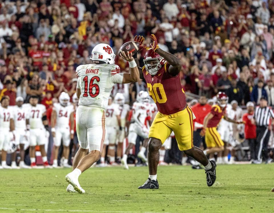 USC defensive lineman Bear Alexander is called "attacking the passer" after meeting Utah QB Bryson Barnes