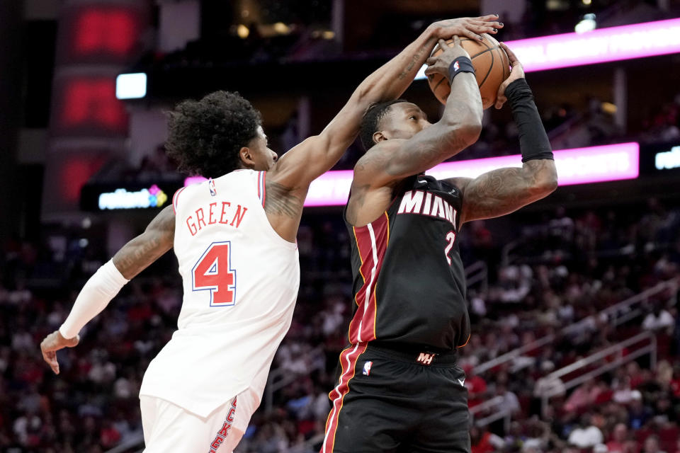 Houston Rockets guard Jalen Green (4) blocks the shot of Miami Heat guard Terry Rozier during the first half of an NBA basketball game Friday, April 5, 2024, in Houston. (AP Photo/Eric Christian Smith)