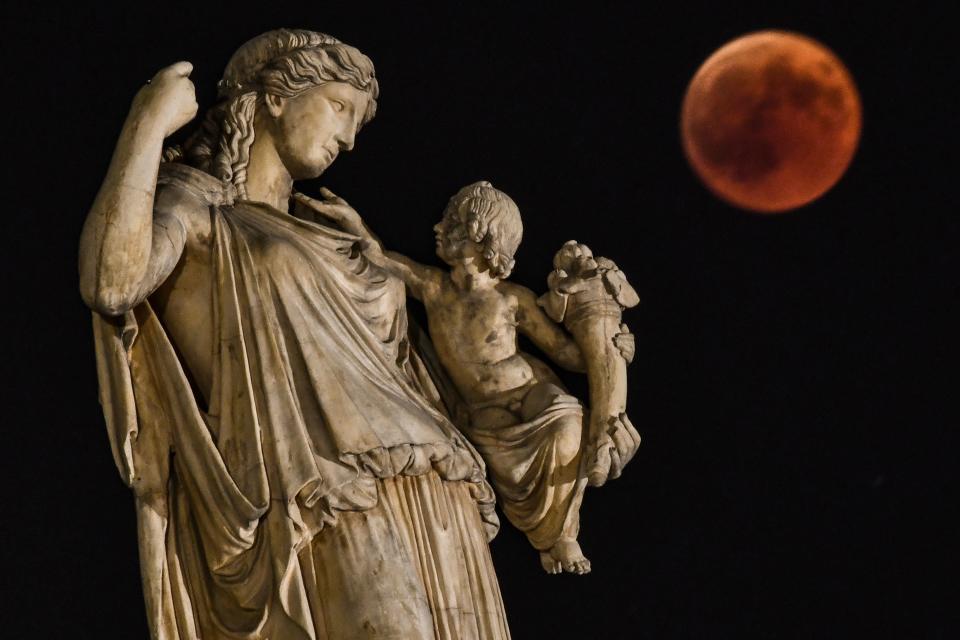 Next to the statue of the ancient Greek goddess Irine&nbsp;in Athens, Greece. (Photo: ARIS MESSINIS via Getty Images)