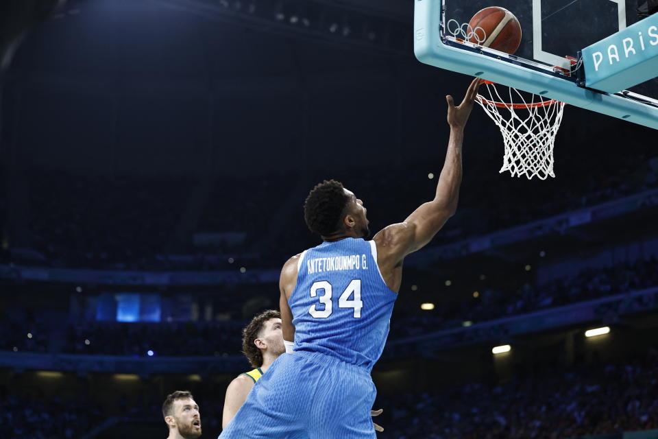 Greece's #34 Giannis Antetokounmpo lays up a ball in the men's preliminary round group A basketball match between Australia and Greece during the Paris 2024 Olympic Games at the Pierre-Mauroy stadium in Villeneuve-d'Ascq, northern France, on August 2, 2024. (Photo by Sameer Al-Doumy / AFP) (Photo by SAMEER AL-DOUMY/AFP via Getty Images)