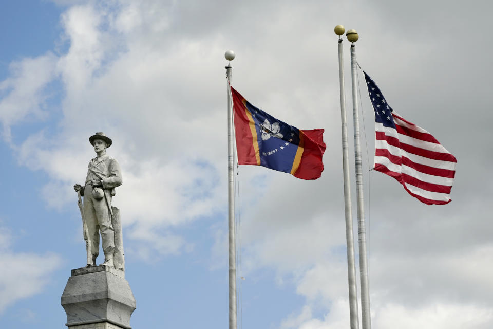 The Mississippi state and U.S. flags fly near the Rankin County Confederate Monument in the downtown square of Brandon, Miss., on Friday, March 3, 2023. Several members of a special unit of the Rankin County sheriff’s department that’s being investigated by the U.S. Justice Department for possible civil rights violations have been involved in at least four violent encounters with Black men since 2019 that left two dead and another with lasting injuries. (AP Photo/Rogelio V. Solis)