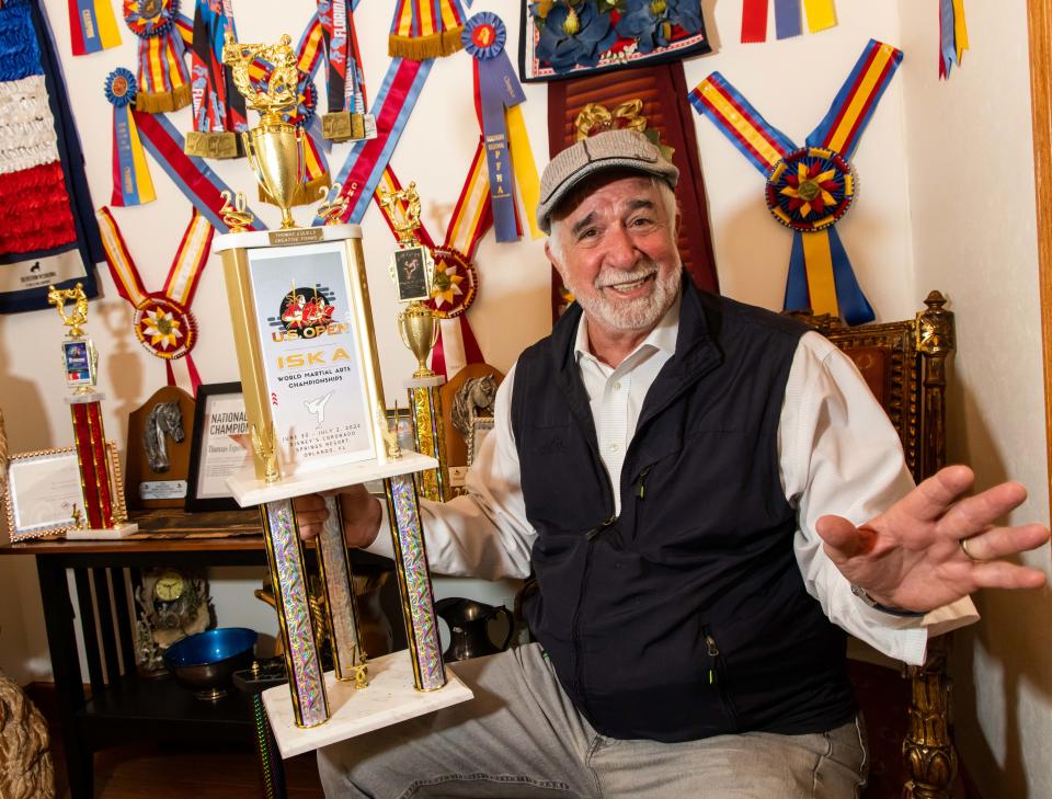 Tom Equels, a veteran and medical industry executive from Ocala, shows off his U.S. Open World Martial Arts Championships trophy from 2022. He won the award after recovering from severe injurie suffered while riding a horse.