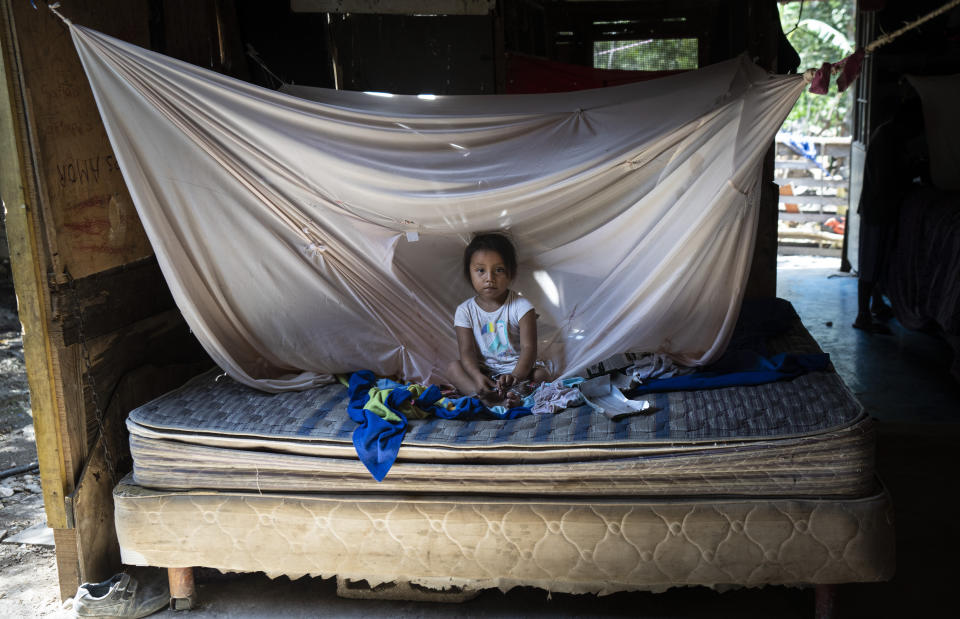 A girl rests at home next to the railway crossing of the Mayan Train project in the Mayan community "Vida y Esperanza," or Life and Hope, on the outskirts of Playa del Carmen, Mexico, Thursday, March 7, 2024. Government officials have promised to bring communities electricity, a sewage system and running water, and agreed to pay more for the land the Mayan Train would pass over. (AP Photo/Rodrigo Abd)