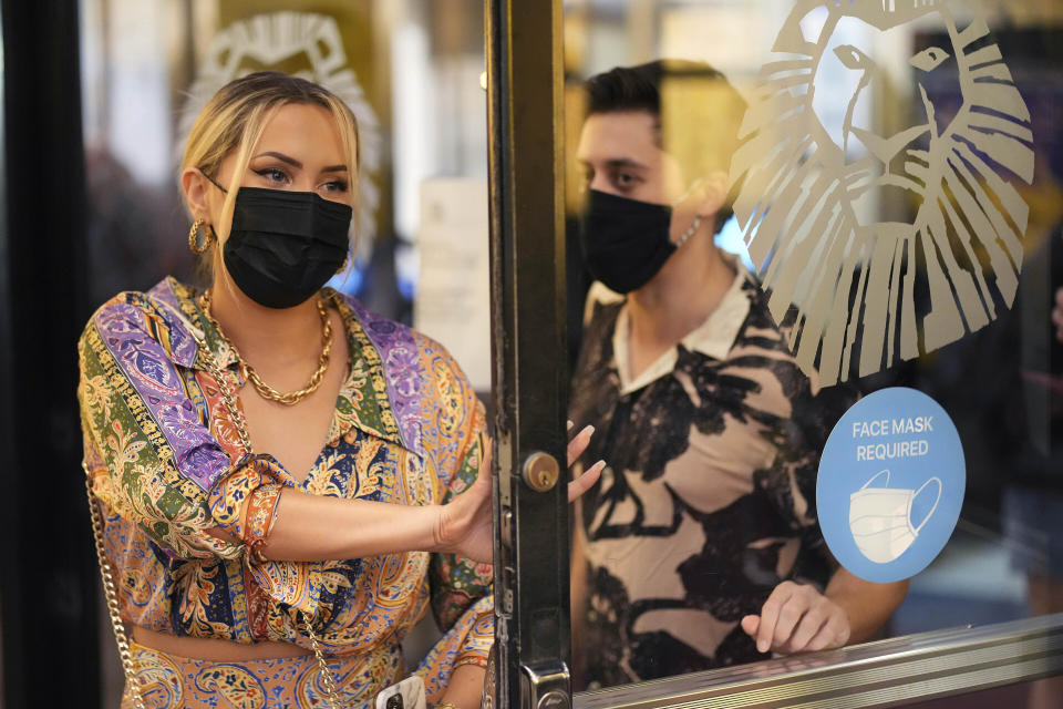 FILE — Theatergoers wear masks to attend a performance of "The Lion King," on Broadway, at the Minskoff Theatre, Sept. 14, 2021, in New York. Facing a winter surge in COVID-19 infections, New York Gov. Kathy Hochul says that masks will be required in all indoor public places unless the businesses or venues implement a vaccine requirement. (Photo by Charles Sykes/Invision/AP, File)
