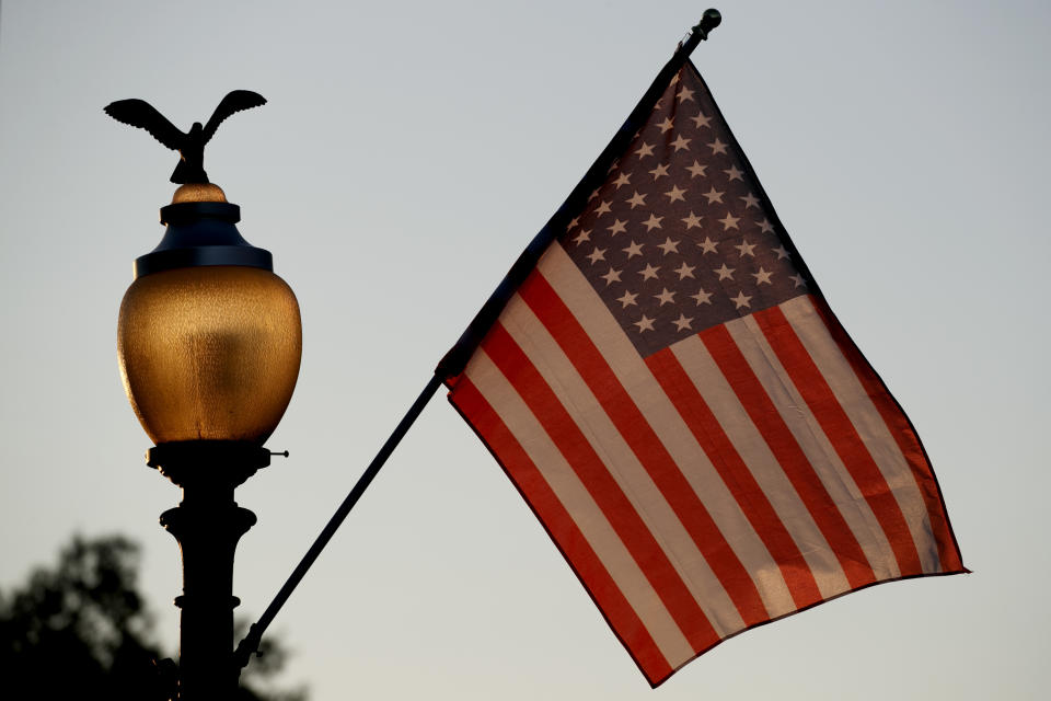 Flags fly at sunset with 51 instead of the usual 50 stars, along Pennsylvania Ave., part of a display in support of statehood for the District of Columbia, Sunday, Sept. 15, 2019, in Washington. (AP Photo/Jacquelyn Martin)