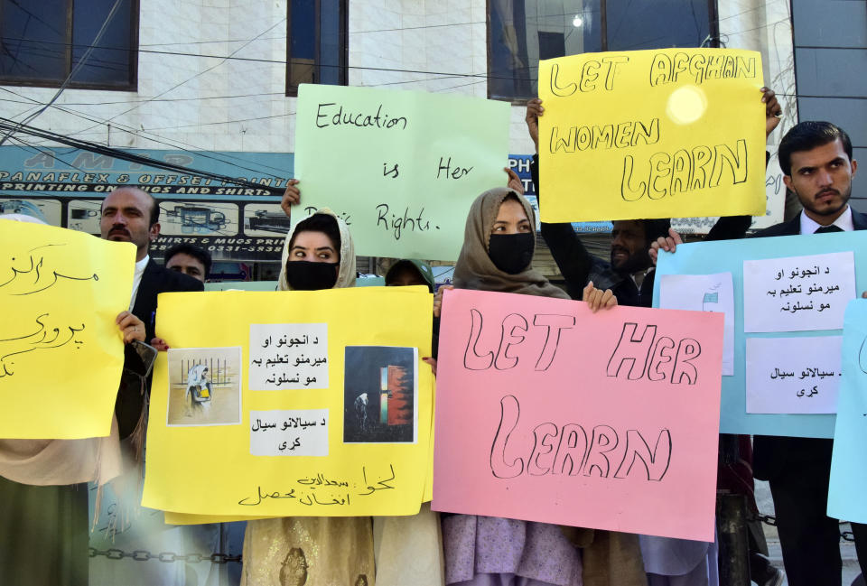 Afghan university students chant slogans and hold placards during a protest against the ban on university education for women, in Quetta, Pakistan, Saturday, Dec. 24, 2022. (AP Photo/Arshad Butt)