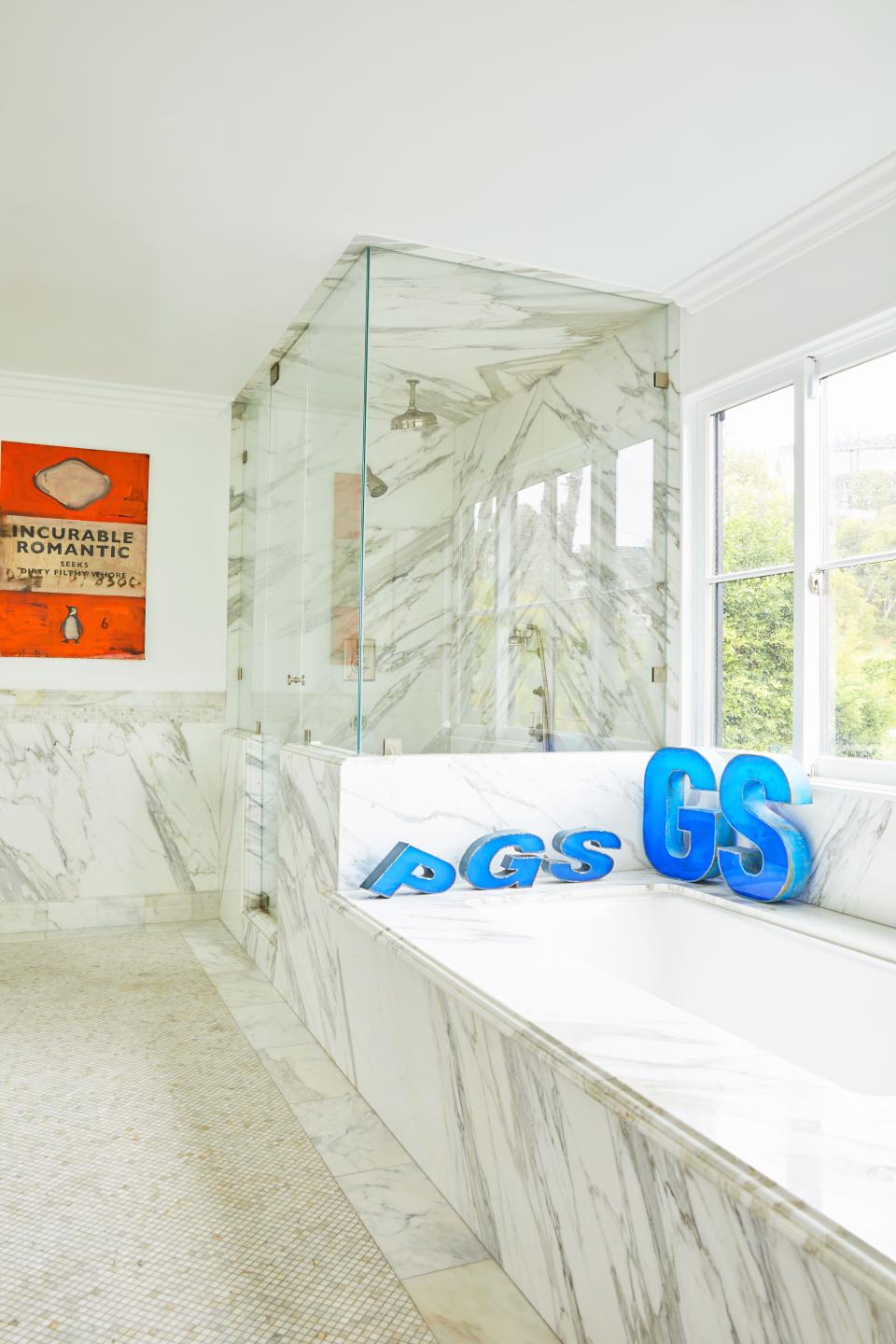 Steele’s marble bathroom (yes, the spouses have separate bathrooms, which they say is “key to the success of our marriage”) has vintage letters from a former gas station in Beirut and a painting by British writer and artist Harland Miller.