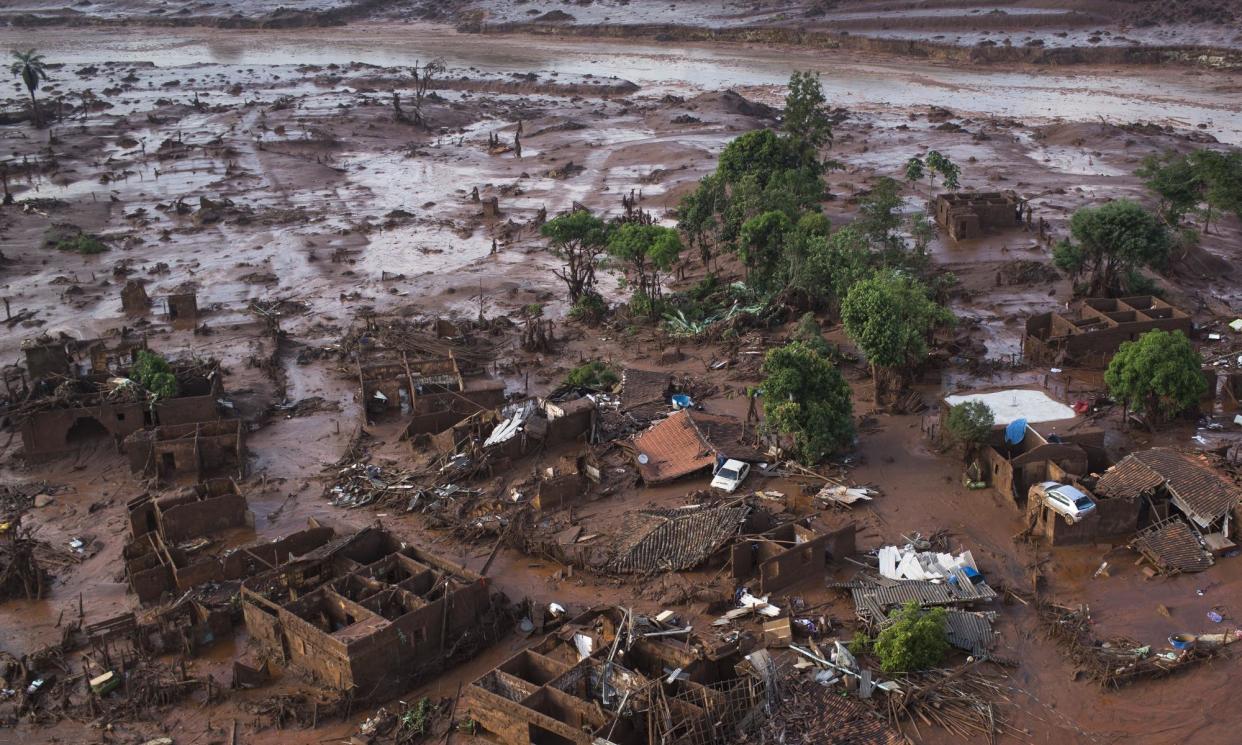 <span>Homes lie in ruins in 2015 after a dam broke inside a mine in Bento Rodrigues, Brazil, jointly owned by Brazilian mining company Vale and Australia’s BHP.</span><span>Photograph: Felipe Dana/AP</span>