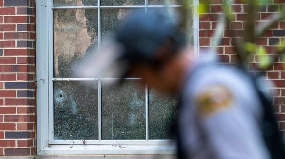 A North Carolina State Trooper surveys the area outside Caudill Laboratories on the first floor of the building where a bullet broke a window on Monday, August 28. 2023 in Chapel Hill, N.C. The building on the University of North Carolina campus is believed to be the site of a shooting that forced the campus into lock down for several hours on Monday afternoon.