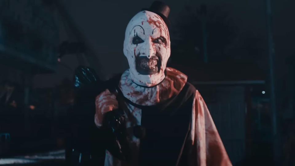 David Howard Thornton walks at night splattered with blood in Terrifier 2.