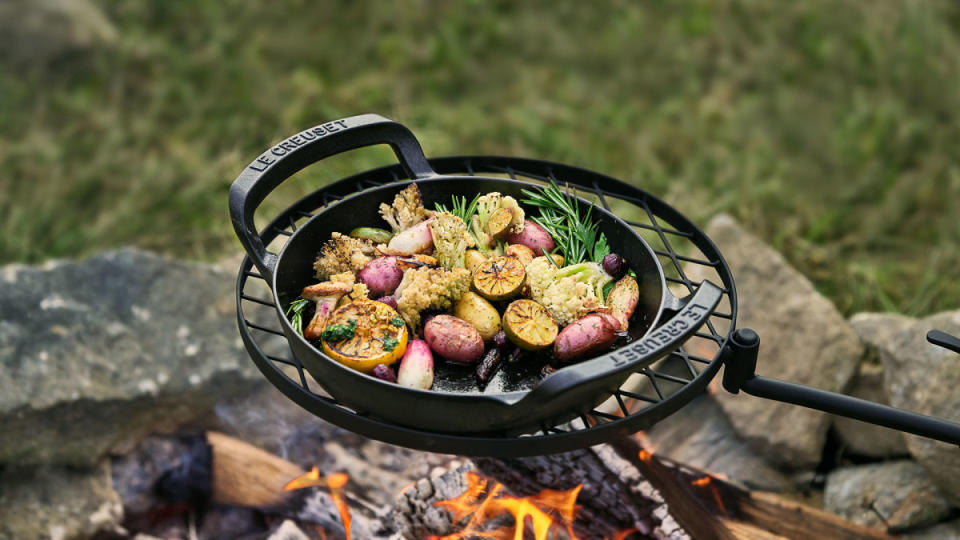 <p>Le Creuset</p><h3><a href="https://clicks.trx-hub.com/xid/arena_0b263_mensjournal?event_type=click&q=https%3A%2F%2Fgo.skimresources.com%2F%3Fid%3D106246X1740122%26url%3Dhttps%3A%2F%2Fwww.lecreuset.com%2Falpine-outdoor-collection-skillet-10-in%2F20270025000001.html&p=https%3A%2F%2Fwww.mensjournal.com%2Fpursuits%2Fhome-living%2Fchoosing-cookware-for-grill-campfire%3Fpartner%3Dyahoo&ContentId=ci02d8b2dc40002684&author=Emily%20Fazio&page_type=Article%20Page&partner=yahoo&section=Outdoor%20Kitchen&site_id=cs02b334a3f0002583&mc=www.mensjournal.com" rel="nofollow noopener" target="_blank" data-ylk="slk:Alpine Outdoor Skillet;elm:context_link;itc:0;sec:content-canvas" class="link ">Alpine Outdoor Skillet</a></h3><p>MSRP: $160</p><p>Every outdoor chef needs a trusty cast iron skillet, and the Alpine Outdoor Skillet will be <strong>an essential piece for your camp kitchen</strong>. Use it to sear, saute, stir-fry, and griddle outdoors. It's an excellent skillet for cuts of meat, fried eggs, toasted sandwiches, and more. <strong>The interior of the skillet is lined with matte black enamel, meaning that it won't require seasoning like traditional cast iron.</strong> Plus, it's easy to clean, which really helps your grilling game.</p><h3><a href="https://clicks.trx-hub.com/xid/arena_0b263_mensjournal?event_type=click&q=https%3A%2F%2Fgo.skimresources.com%2F%3Fid%3D106246X1740122%26url%3Dhttps%3A%2F%2Fwww.lecreuset.com%2Falpine-outdoor-collection-square-grill-basket-12-in%2F20271030000001.html&p=https%3A%2F%2Fwww.mensjournal.com%2Fpursuits%2Fhome-living%2Fchoosing-cookware-for-grill-campfire%3Fpartner%3Dyahoo&ContentId=ci02d8b2dc40002684&author=Emily%20Fazio&page_type=Article%20Page&partner=yahoo&section=Outdoor%20Kitchen&site_id=cs02b334a3f0002583&mc=www.mensjournal.com" rel="nofollow noopener" target="_blank" data-ylk="slk:Alpine Outdoor Square Grill Basket;elm:context_link;itc:0;sec:content-canvas" class="link ">Alpine Outdoor Square Grill Basket</a></h3><p>MSRP: $160</p><p>We've tried traditional grilling baskets, but there's something about the heat distribution across an enameled cast iron grill basket that makes us excited to sauté, stir-fry, and roast dinner. <strong>Perfectly sized to fit on most grills or for use over an open flame</strong>, the Alpine Outdoor Square Grill Basket requires no seasoning. The perforations in the grill basket are small enough to prevent foods from falling through, but open enough to welcome the smoky, chargrilled flavors into your meal. <strong>Try it for fish, shrimp, french fries, asparagus, and small vegetables</strong> — you can make a complete dish on this piece. </p>