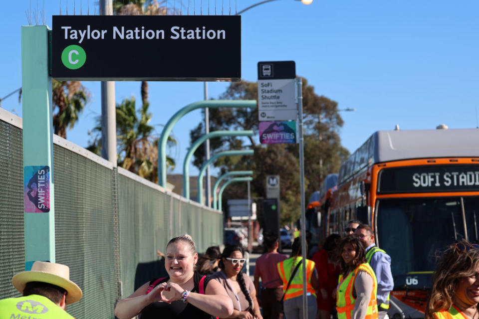 Swifties arrive to take a free shuttle bus from the temporarily renamed "Taylor Nation Station" Metro C Line Station to SoFi stadium