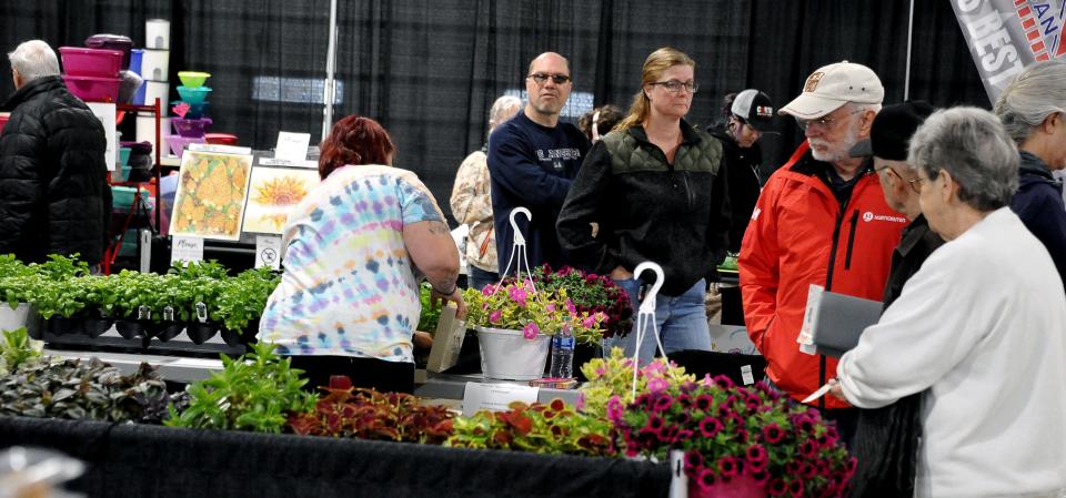 Plant booths are scattered throughout the Home and Garden Show at the Wayne County Fair Event Center in Wooster. The show continues Sunday.