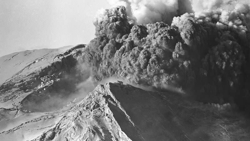 A large crater can be seen at left as Mount St. Helens erupts on April 2, 1980, spewing black smoke and ash skyward. Mount St. Helens is located 45 miles northeast of Portland, Oregon, in Washington.