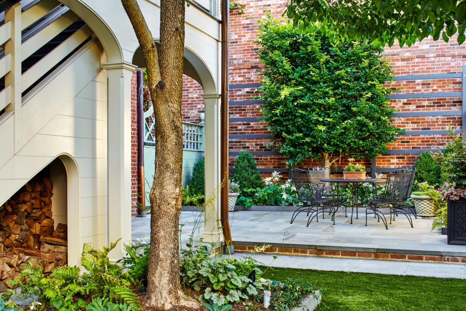 backyard garden patio with bistro set and garden border by Joseph Richardson of Richardson & Associates Landscape Architecture