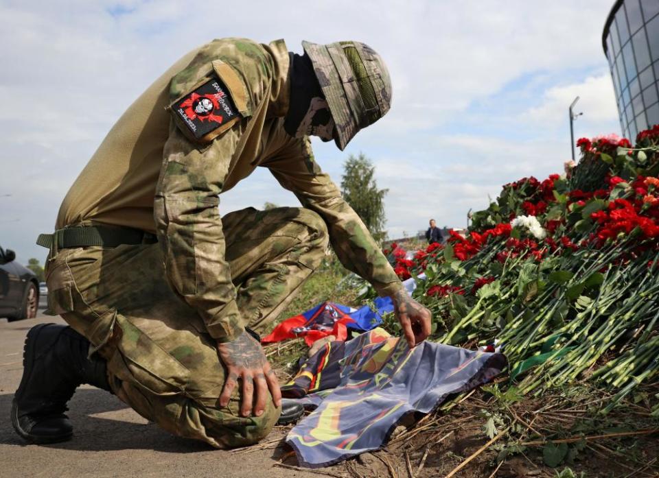 A Wagner fighter at a makeshift memorial for Yevgeny Prigozhin in Saint Petersburg on Friday.