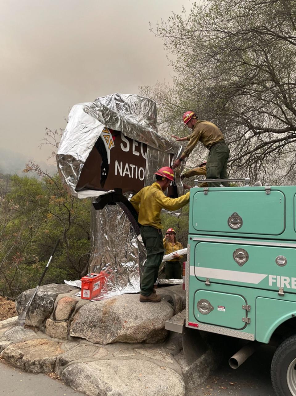 Firefighters put protective foil over historic Sequoia National Park Sign