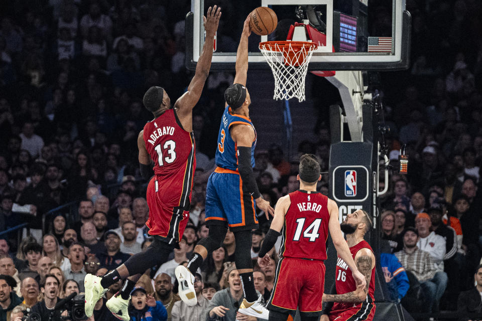 New York Knicks guard Josh Hart (3) dunks ahead of Miami Heat center Bam Adebayo (13) during the first half of an NBA basketball game on Saturday, Jan. 27, 2024, in New York. (AP Photo/Peter K. Afriyie)