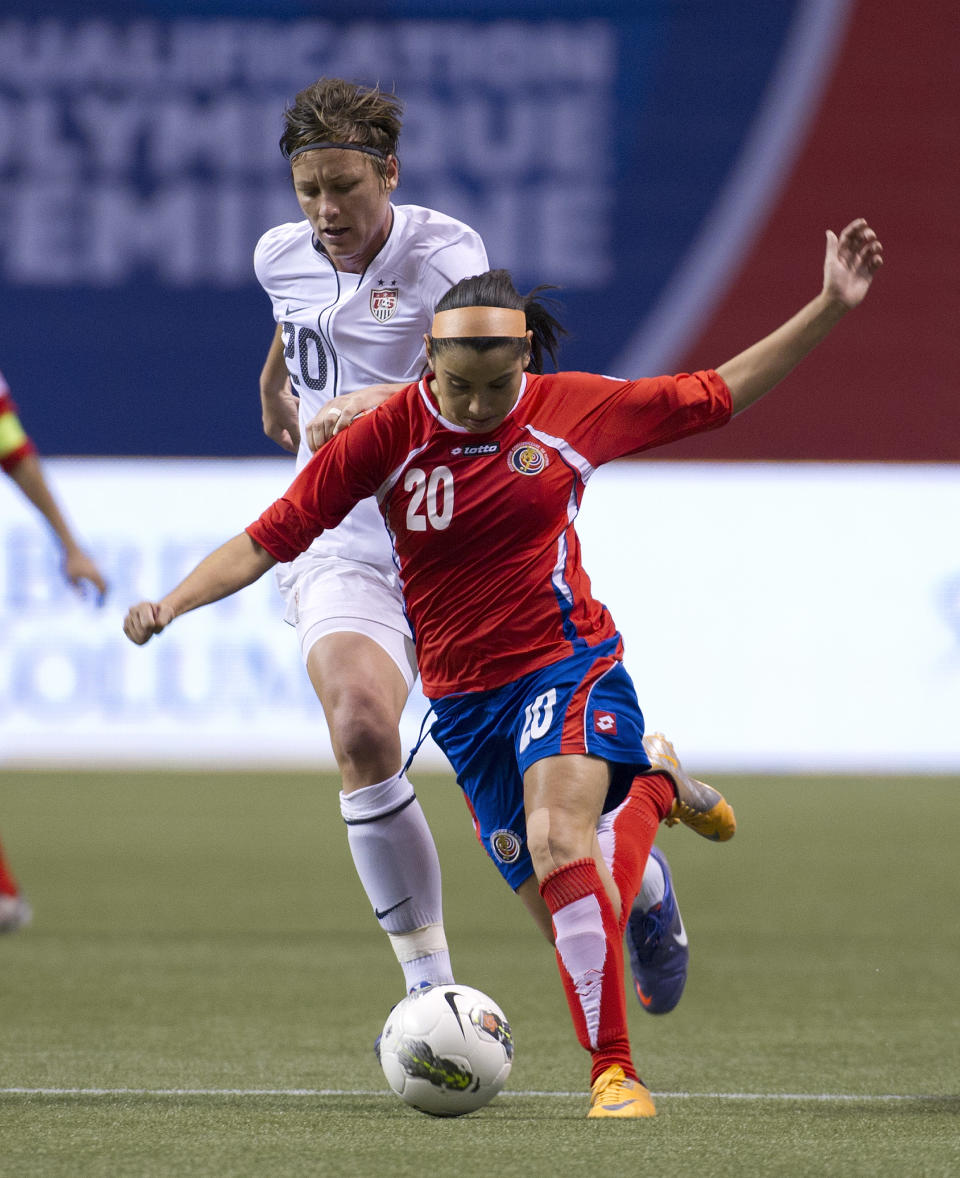 VANCOUVER, CANADA - JANUARY 27: Wendy Acosta #20 of Costa Rica is challenged by Abby Wambach #20 of the United States during the second half of semifinals action of the 2012 CONCACAF Women's Olympic Qualifying Tournament at BC Place on January 27, 2012 in Vancouver, British Columbia, Canada. (Photo by Rich Lam/Getty Images)