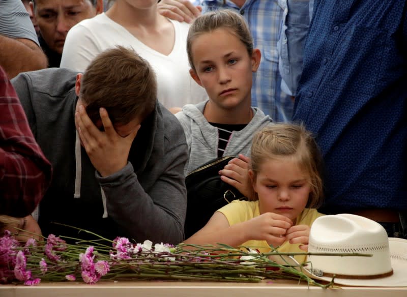 Relatives react during the funeral of Miller and her children who were killed by unknown assailants in LeBaron