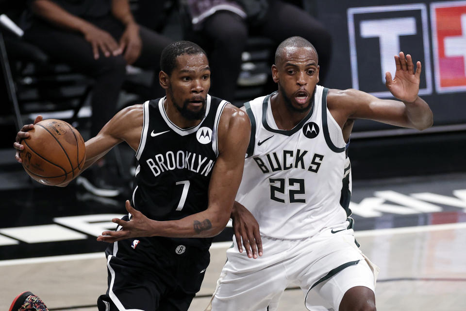 Brooklyn Nets forward Kevin Durant (7) drives to the basket past Milwaukee Bucks forward Khris Middleton during the second half of Game 1 of an NBA basketball second-round playoff series Saturday, June 5, 2021, in New York. (AP Photo/Adam Hunger)