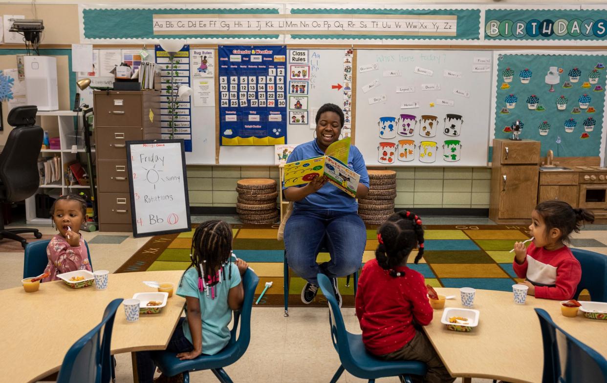 Aaliyah Morrison, an assistant teacher for Bottles-N-Backpacks, reads a book to her students during a class inside the Chapelle Business Center in Ypsilanti on Friday, Dec. 8, 2023.
