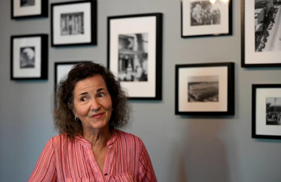 Melanie Knowles describes the stories behind the black and white photos in the private dining area at EnRich Bistro in Bradenton on Tuesday, May 14, 2024.
