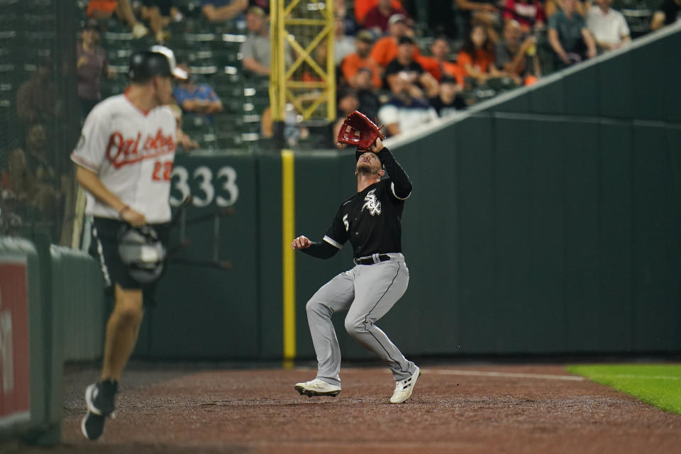 Chicago White Sox center fielder Adam Engel chases a foul ball by Baltimore Orioles' Kyle Stowers during the ninth inning of a baseball game, Thursday, Aug. 25, 2022, in Baltimore. Engel dropped the ball, which would have been the final out of the game. The Orioles won 4-3 in 11 innings. (AP Photo/Julio Cortez)