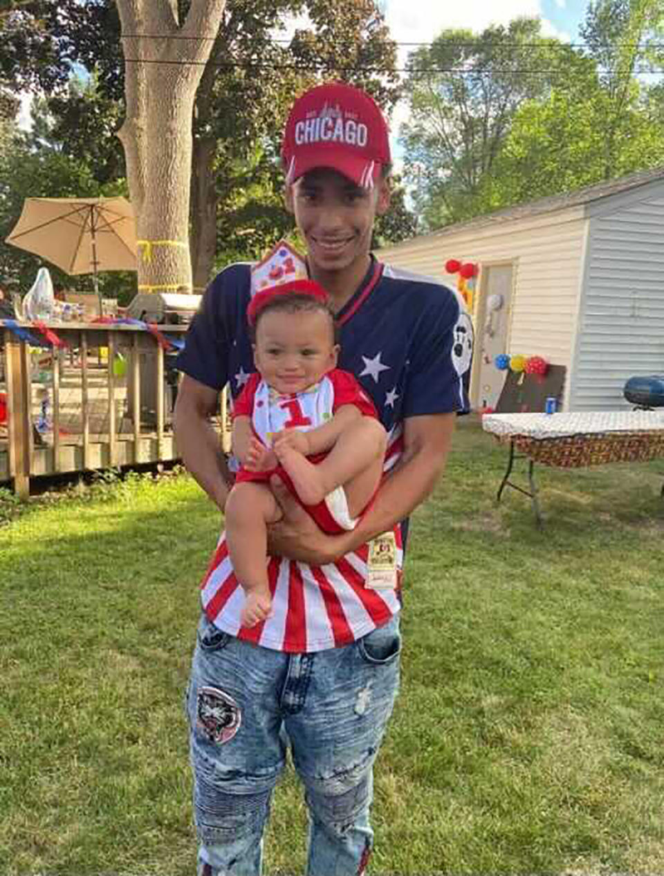 This photo provided by Ben Crump Law, PLLC. shows Daunte Wright and his son Daunte Jr., at his first birthday party. A white police officer who fatally shot Daunte Wright during a traffic stop in a Minneapolis suburb resigned Tuesday, April 13, 2021 as did the city's police chief — moves that the mayor said he hoped would help heal the community and lead to reconciliation after two nights of protests and unrest. (Ben Crump Law, PLLC. via AP)