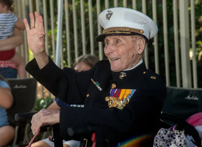Retired USMC Major Bill White waves to well-wishers in their cars as they parade by for his 106th birthday at the Oaks at Inglewood retirement community in Stockton. White, a WWII veteran, thanked and waved to drivers and passengers as they wished him a Happy Birthday. In 2020 White started Operation Valentines by asking people to send him cards on Valentine's Day. He received hundreds of thousands of cards from all around the world. 