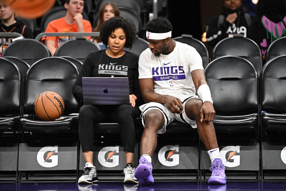 Lindsey Harding and Kings guard Terence Davis watch film on the bench before a game against the Suns on Feb. 14, 2023. Harding was hired as head coach of the Kings&#39; G League team. (John W. McDonough/Sports Illustrated via Getty Images)