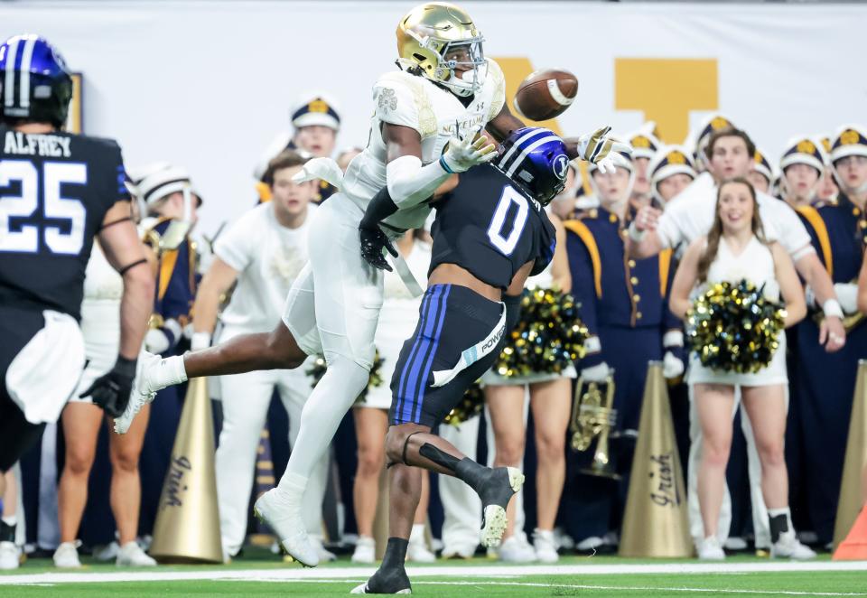 Notre Dame Fighting Irish wide receiver Jayden Thomas (83) makes a reception over Brigham Young Cougars defensive back Jakob Robinson (0) and runs it in for a touchdown, putting the Irish up 18-6, at Allegiant Stadium in Las Vegas on Saturday, Oct. 8, 2022.