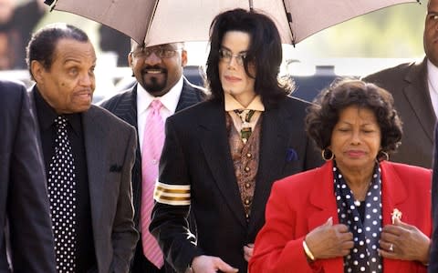 Michael Jackson with his father Joe and mother Katherine at court in 2005 for the singer's child molestation trial - Credit: Getty Images North America