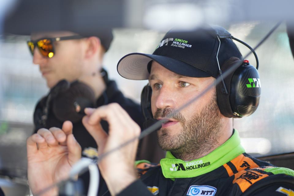 Agustin Canapino, of Argentina, talks with his team during a practice session for the IndyCar Grand Prix auto race at Indianapolis Motor Speedway, Friday, May 10, 2024, in Indianapolis. (AP Photo/Darron Cummings)