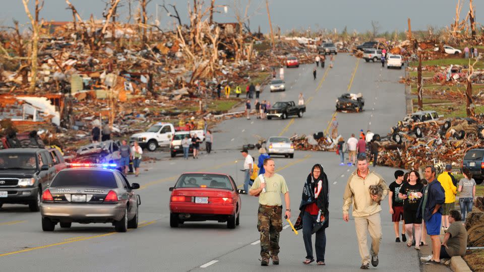 Residents walk in the street after a massive tornado hit Joplin, Missouri, on May 22, 2011. - Mike Gullett/AP