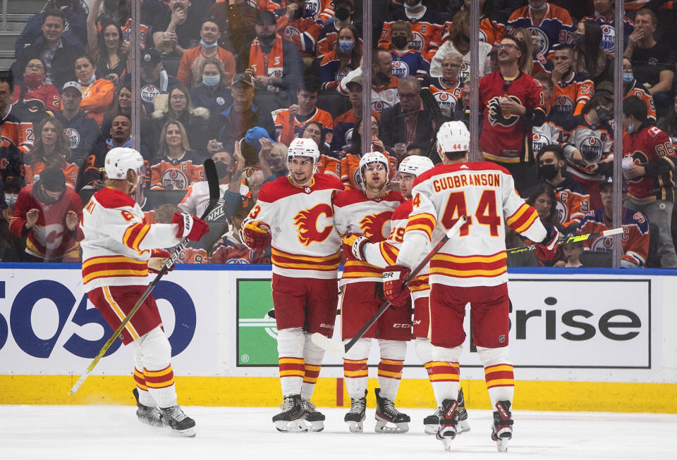 Calgary Flames celebrate a goal against the Edmonton Oilers' during the second period of an NHL hockey game Saturday, Oct. 16, 2021, in Edmonton, Alberta. (Jason Franson/The Canadian Press via AP)